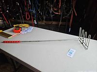 Full view showing adjustable aluminum handle, red grip, five-tine head