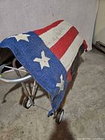 Full view of blanket draped on stand showing overall flag pattern