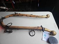 Full view of both wooden hames showing brass finials and iron hardware