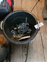 overview of bucket containing assorted hardware