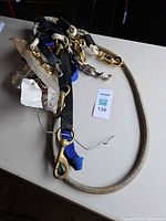 Pile of assorted leashes, collars and hardware on table