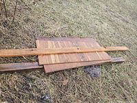 Stack of plywood sheets and boards on grass