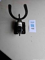 Overall view of black metal horseshoe wall hook on mounting plate