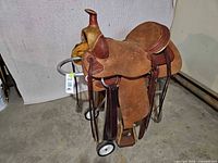 Full side view of Blue River Saddlery Western saddle on stand