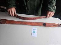 Full view of both leather strap pieces laid out on table