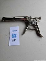 Full view of veterinary syringe with MaxSold lot card