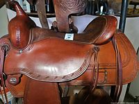 Left side view showing seat, pommel, cantle, skirt, fender, overall condition