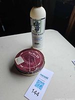 Both items together: Cowboy Magic bottle and Ruiz Diaz polish tin