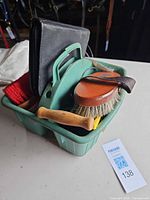 Overall view of grooming kit in green tote showing multiple items