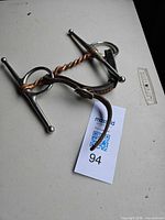 Overall view of full cheek horse bit with twisted copper mouthpiece and leather straps