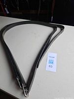 Entire pair of black leather reins laid out flat