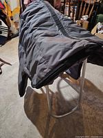 Overall view of gray nylon saddle bag draped to show size and color