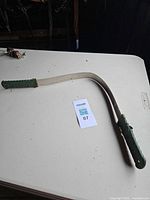 Full view of shedding blade showing overall form and both handles