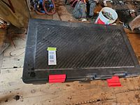 Top view of black storage locker with red latches