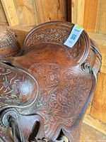 Left side view of entire saddle showing floral tooling and tag 193