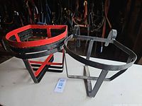 two metal feed racks, one rectangular, one semicircular