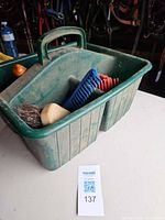 Overall view of green plastic tote with contents visible