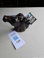 Angled view of horse head hitch cover with attached tag