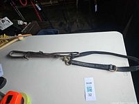 Full view of leather and nylon martingale tie-down assembly on table