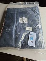 Sealed package showing folded navy sheet