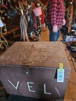 Front view of brown OSB chest showing letters and latch