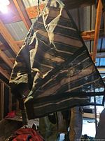 Full view of hanging mesh horse blanket showing size and striped pattern