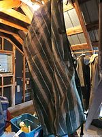 Full view of hanging horse blanket showing size and stripe pattern