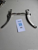 Full view of stainless steel loose ring snaffle bit with tag