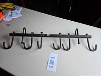 Full view of six-hook metal rack