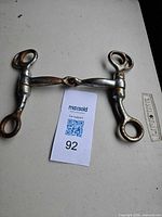 Overall view of full horse bit showing complete form and rust