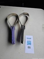 Both shedding straps side by side displaying handle colors and overall form