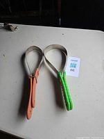 Two shedding blades looped, orange and green handles visible