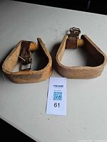 both wooden stirrups side by side on table