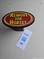 Front view of oval hitch cover with text