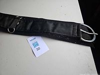 Full view of girth showing nylon webbing, fleece underside and roller buckle end with 30 tag