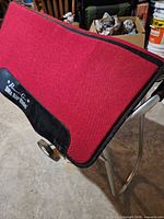 Full view of red saddle pad draped over stand