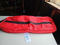 Full view of red bridle bag showing length and zipper