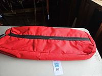 Full view of red bridle bag showing length and zipper