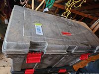 Closed Rubbermaid chest showing size, gray body, red latches