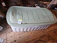 Full view of Rubbermaid deck box with green lid and gray base