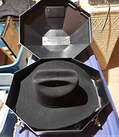 Hat in open octagonal hard case
