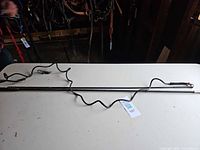 Both riding crop and lunge whip on table full length