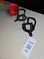 Lot overview showing three metal wall hangers