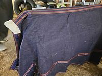 Full view of navy blanket showing trim and overall condition