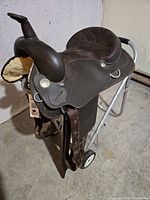 Full view of Wintec Western saddle on stand showing 16 in seat, stirrups and girth