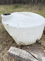 Full view of white polyethylene tank with lid and outlet fitting