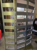 Front view of full three-panel aluminum loading ramp standing upright