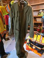 Olive green coveralls displayed full length