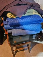 Stack of moving pads and fleece blankets showing colors and quilted pattern
