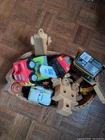 Basket containing assorted wooden and plastic toy vehicles